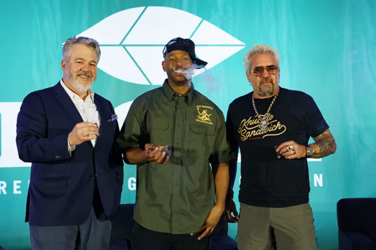 three guys smoking cigars, a publisher, a comedian and a reality tv star.